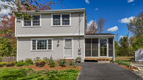 a view of a house with a yard and sitting space