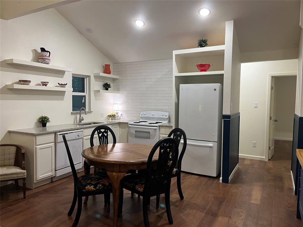315 Hobson Street Weatherford, TX 76086 - Photo 2 of 24 Kitchen featuring wood-finish flooring, white cabinetry, and includes refrigerator