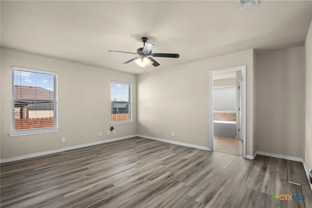 wooden floor in an empty room with a window