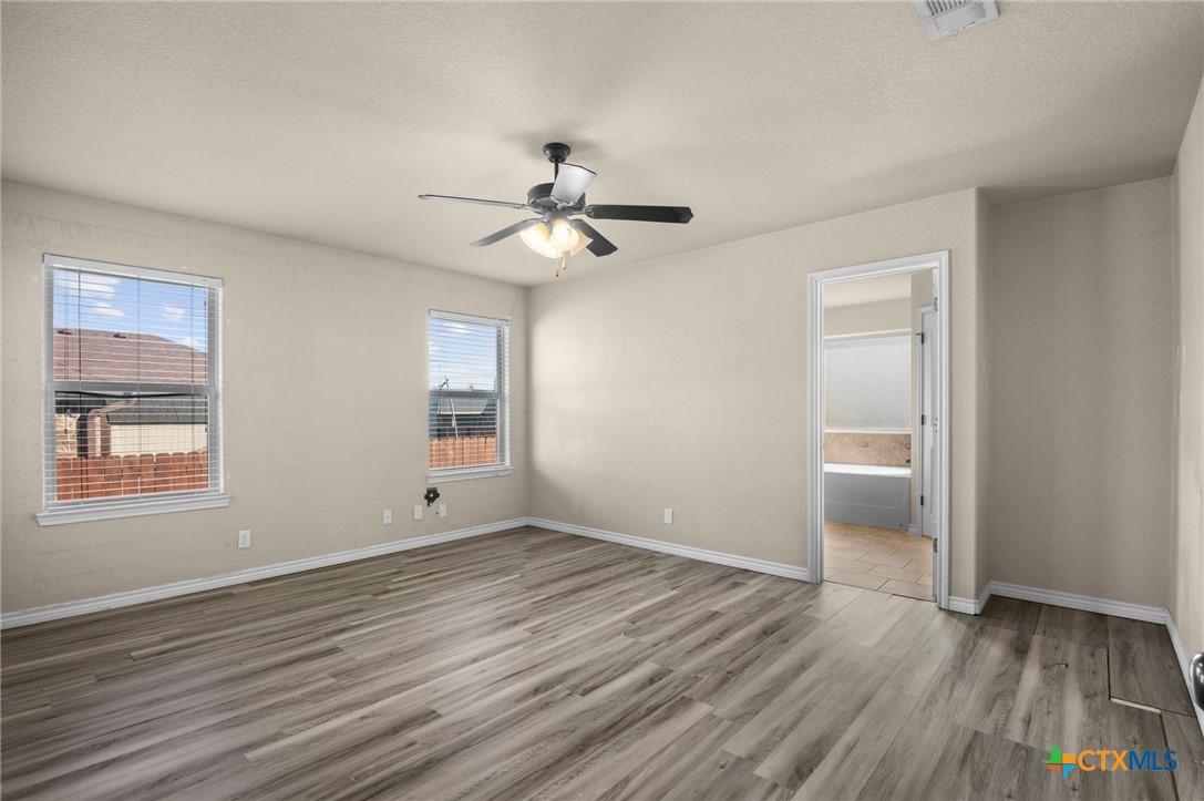 3710 Anvil Range Road Killeen, TX 76549 - Photo 16 of 32 wooden floor in an empty room with a window