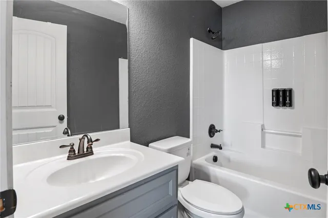 a bathroom with a sink a toilet and a bathtub