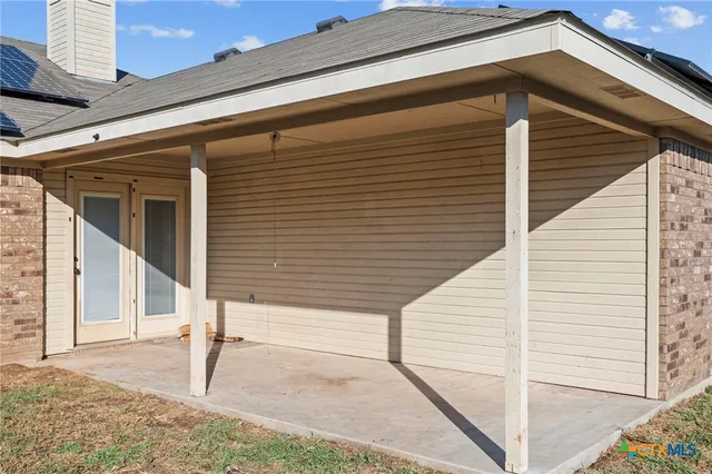 a view of a house with wooden fence