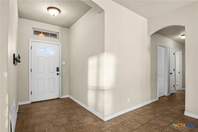 a view of a hallway to rooms