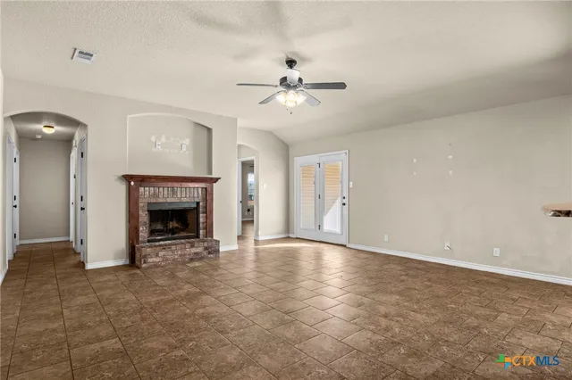 a view of an empty room with a fireplace
