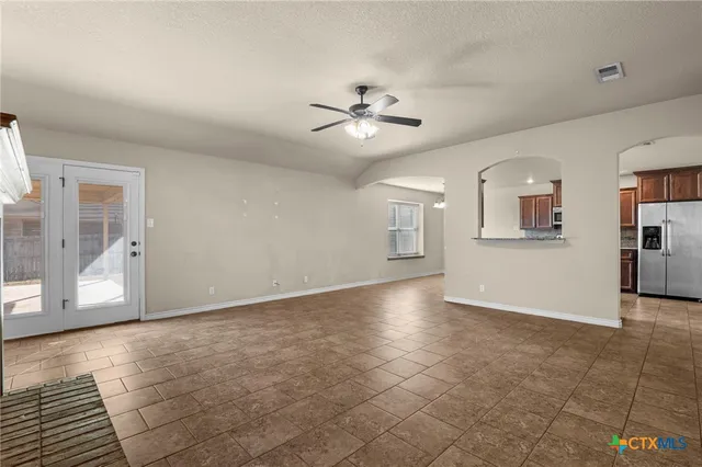 a view of a livingroom with a ceiling fan and window