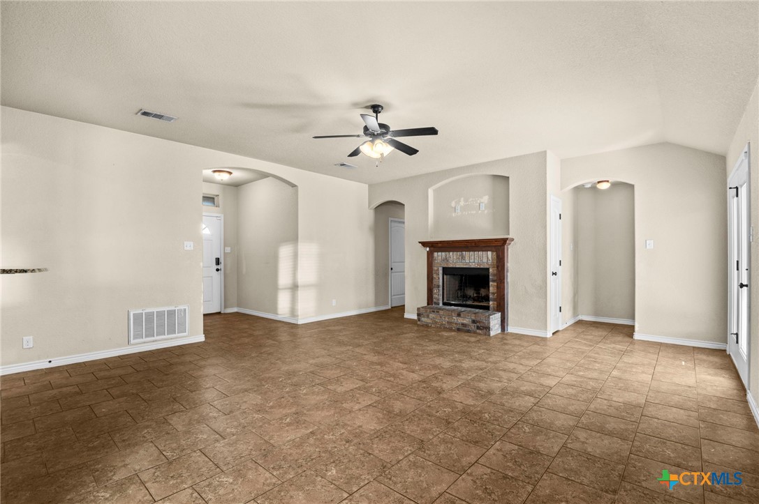 3710 Anvil Range Road Killeen, TX 76549 - Photo 10 of 32 a view of an empty room with chandelier fan and fire place