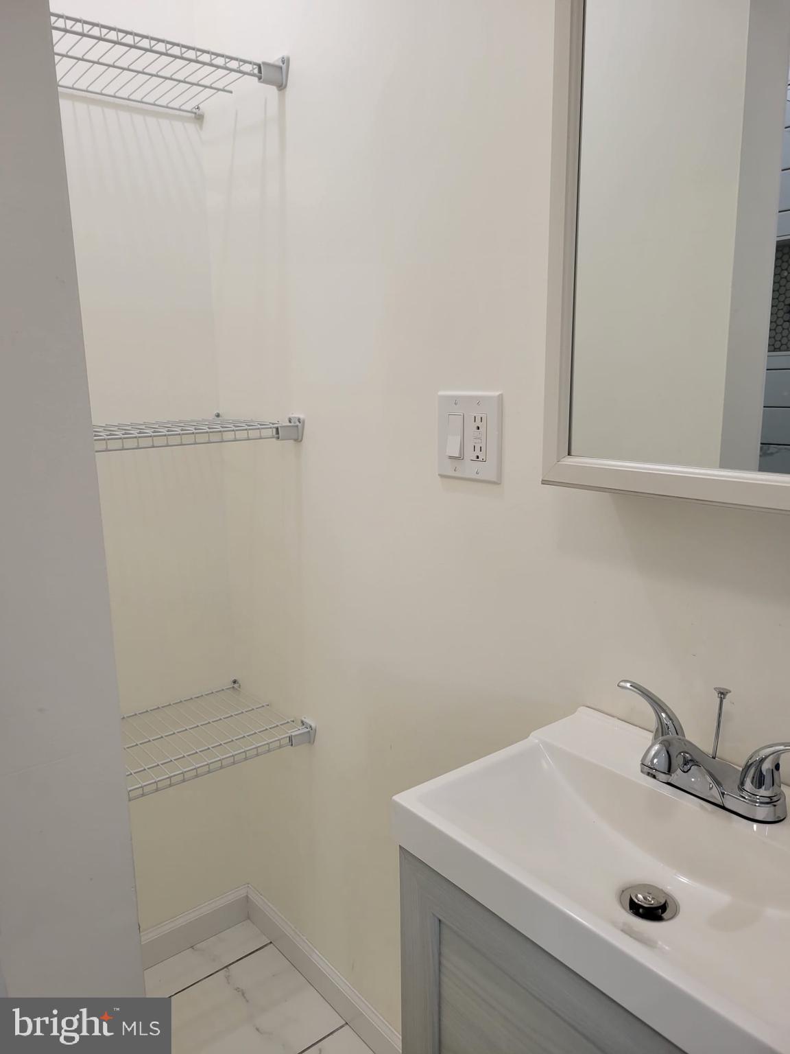 616 Tasker Street, Unit 2 Philadelphia, PA 19148 - Photo 14 of 22 a bathroom with a sink and mirror