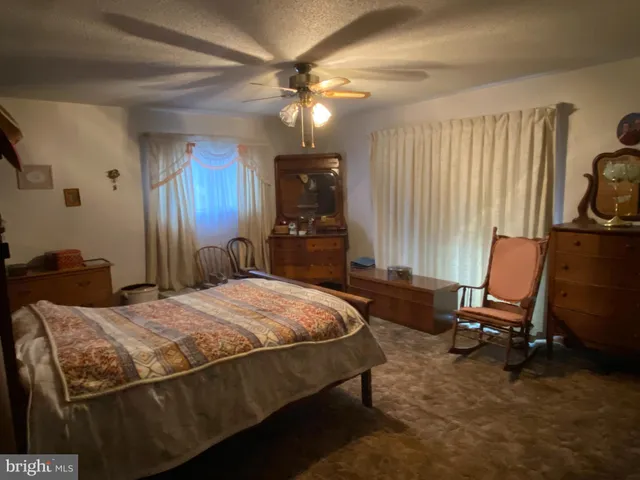 a bed room with a bed window and a chair