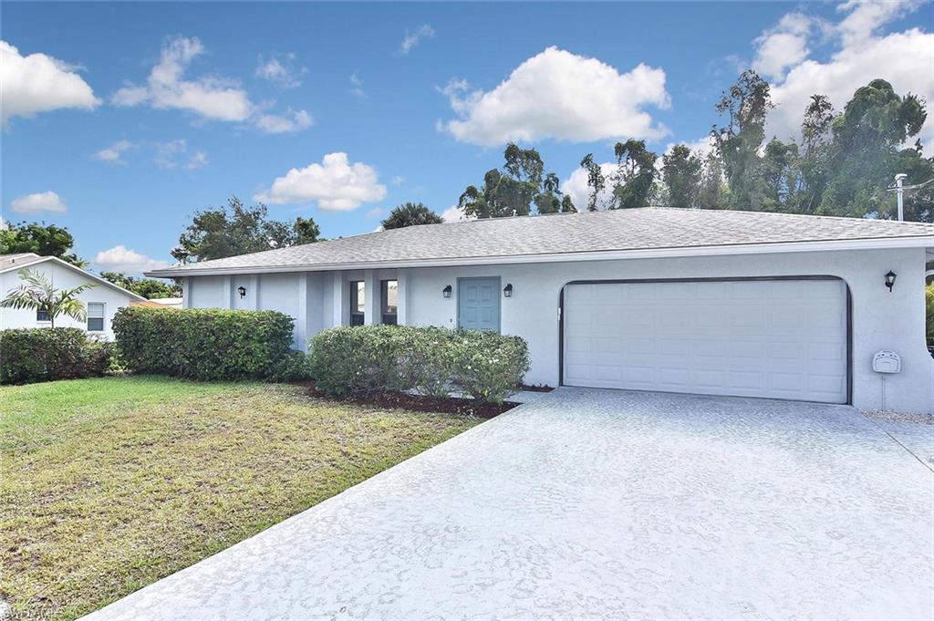 17533 Oriole Road Fort Myers, FL 33967 - Photo 1 of 35 a front view of a house with garden