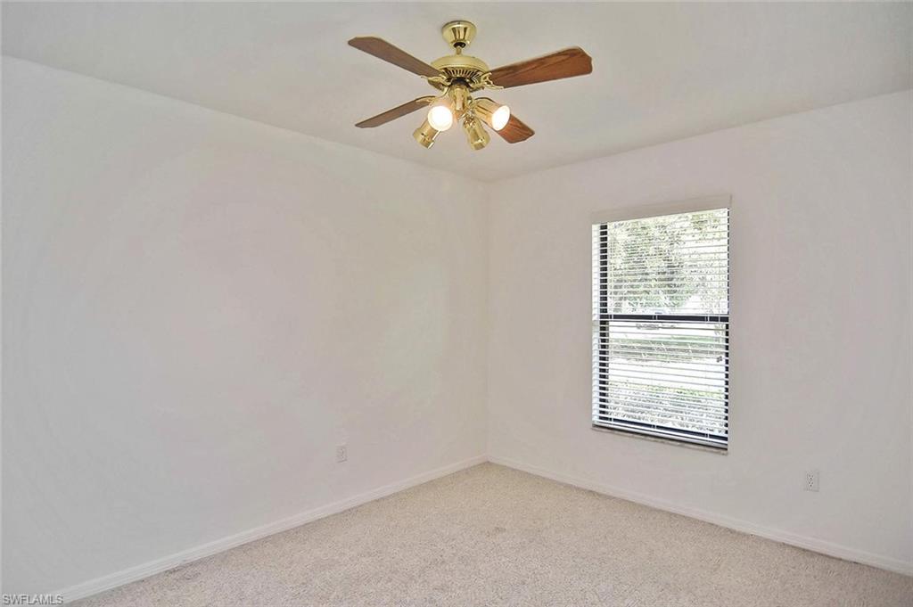 17533 Oriole Road Fort Myers, FL 33967 - Photo 23 of 35 an empty room with windows and fan