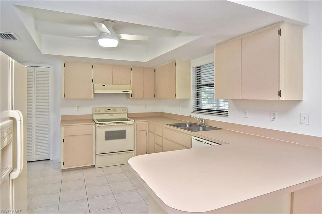 17533 Oriole Road Fort Myers, FL 33967 - Photo 7 of 35 a kitchen with a stove a sink and a refrigerator