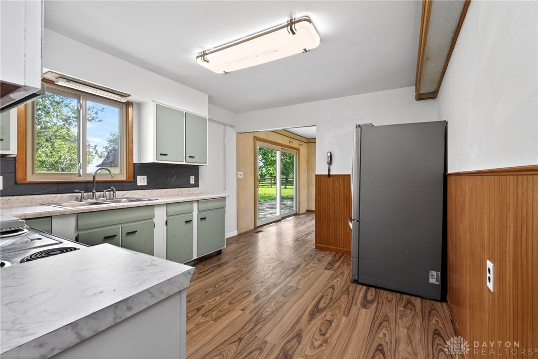 1005 Free Road New Carlisle, OH 45344 - Photo 18 of 43 This spacious kitchen offers ample light and backyard access, perfect for gatherings.