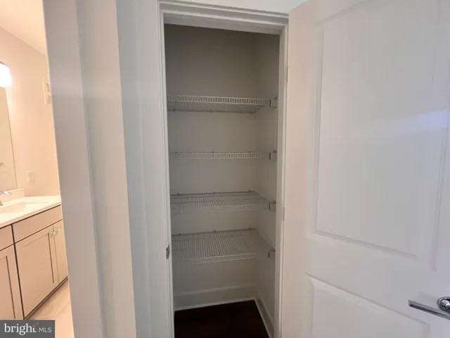 a view of walk in closet with empty racks