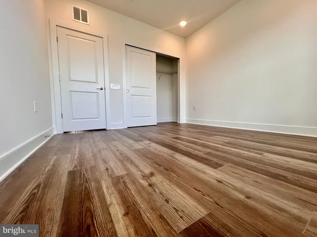 a view of wooden floor and brick walls