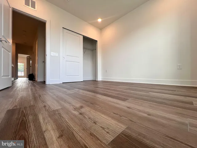 a view of an empty room and wooden floor