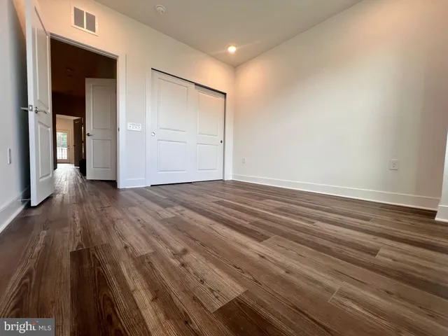 a view of room with window and wooden floor