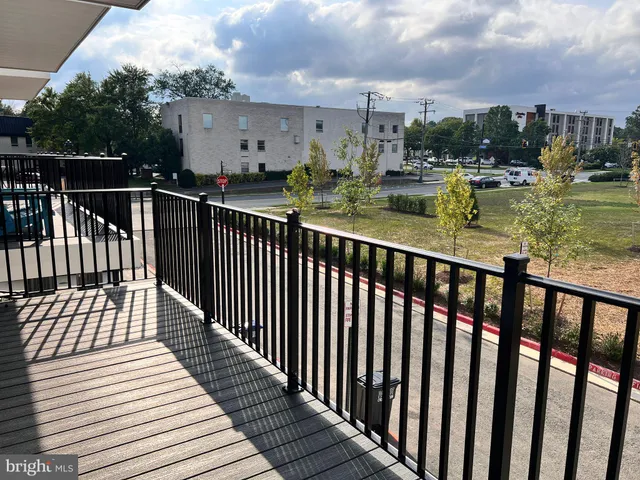a view of a balcony with wooden floor and city view