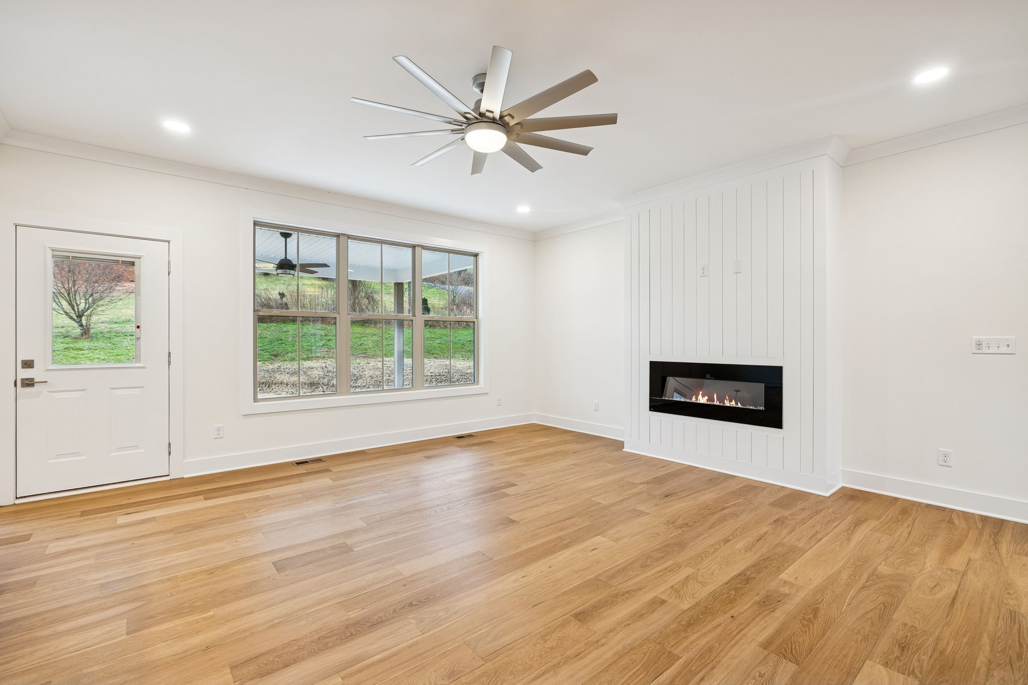 1561 Opossum Paw Road Beechgrove, TN 37018 - Photo 13 of 62 a view of an empty room with wooden floor and a window