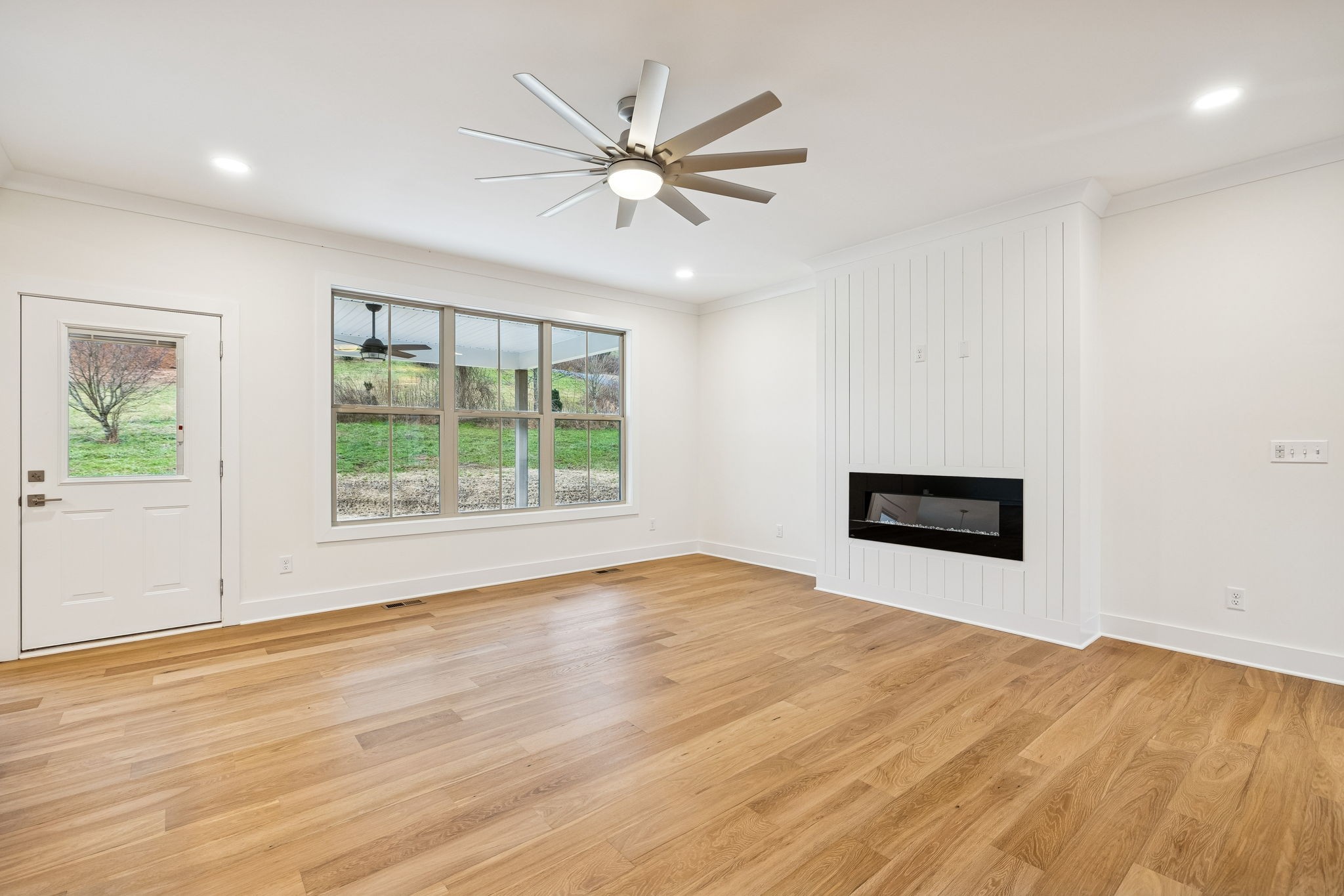 1561 Opossum Paw Road Beechgrove, TN 37018 - Photo 14 of 62 a view of an empty room with wooden floor and a window