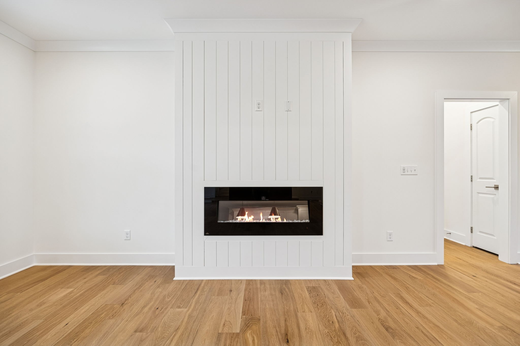 1561 Opossum Paw Road Beechgrove, TN 37018 - Photo 19 of 62 a view of an empty room with wooden floor and a fireplace