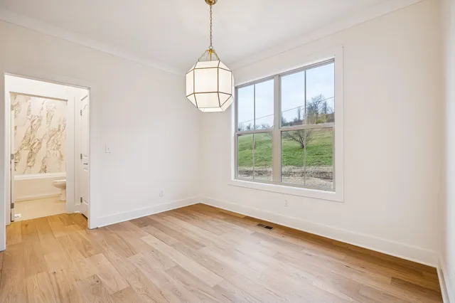 a view of a kitchen with kitchen island a counter top space a sink and appliances