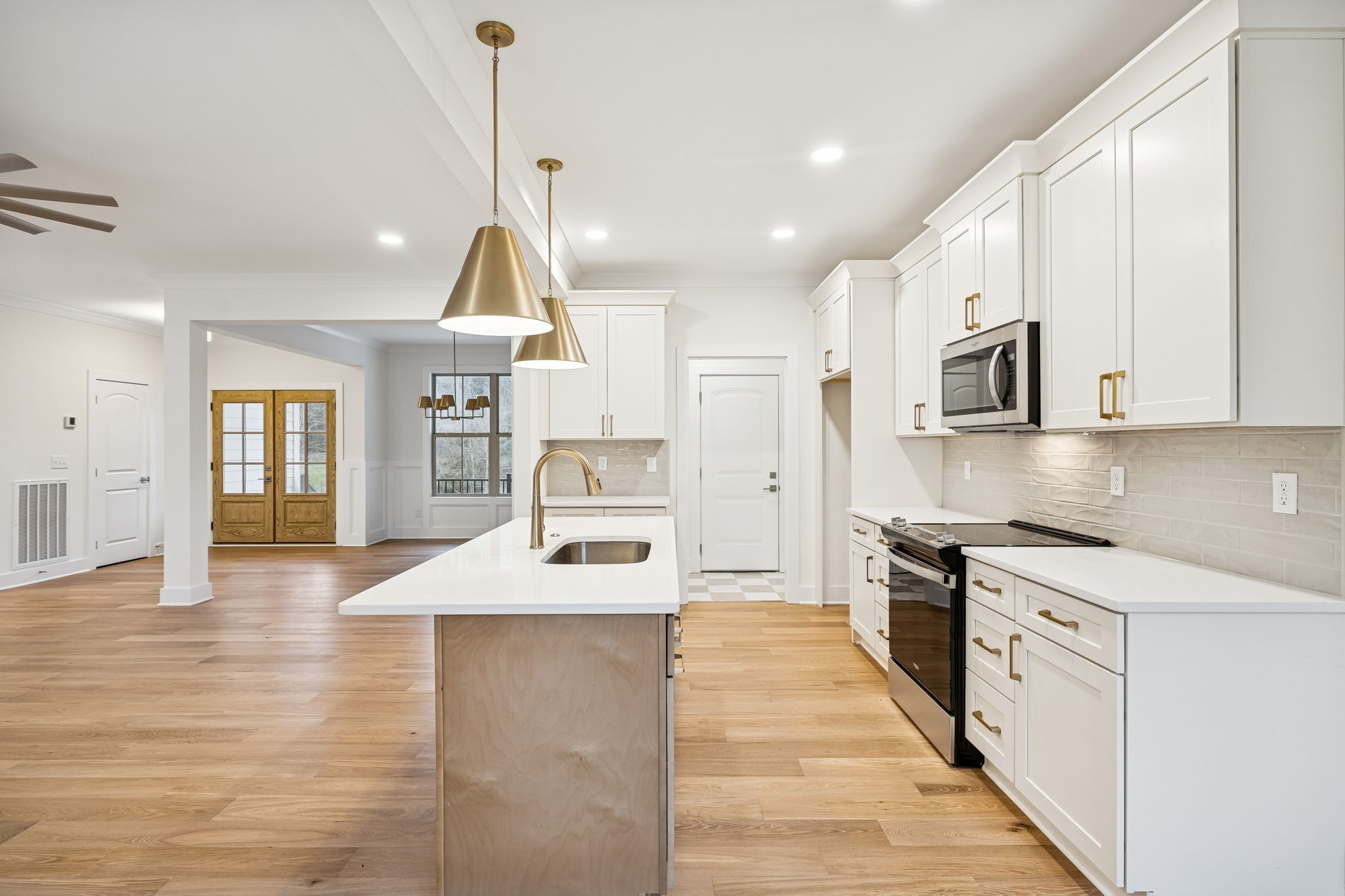 1561 Opossum Paw Road Beechgrove, TN 37018 - Photo 26 of 62 a kitchen with stainless steel appliances granite countertop a sink a stove and a wooden floors