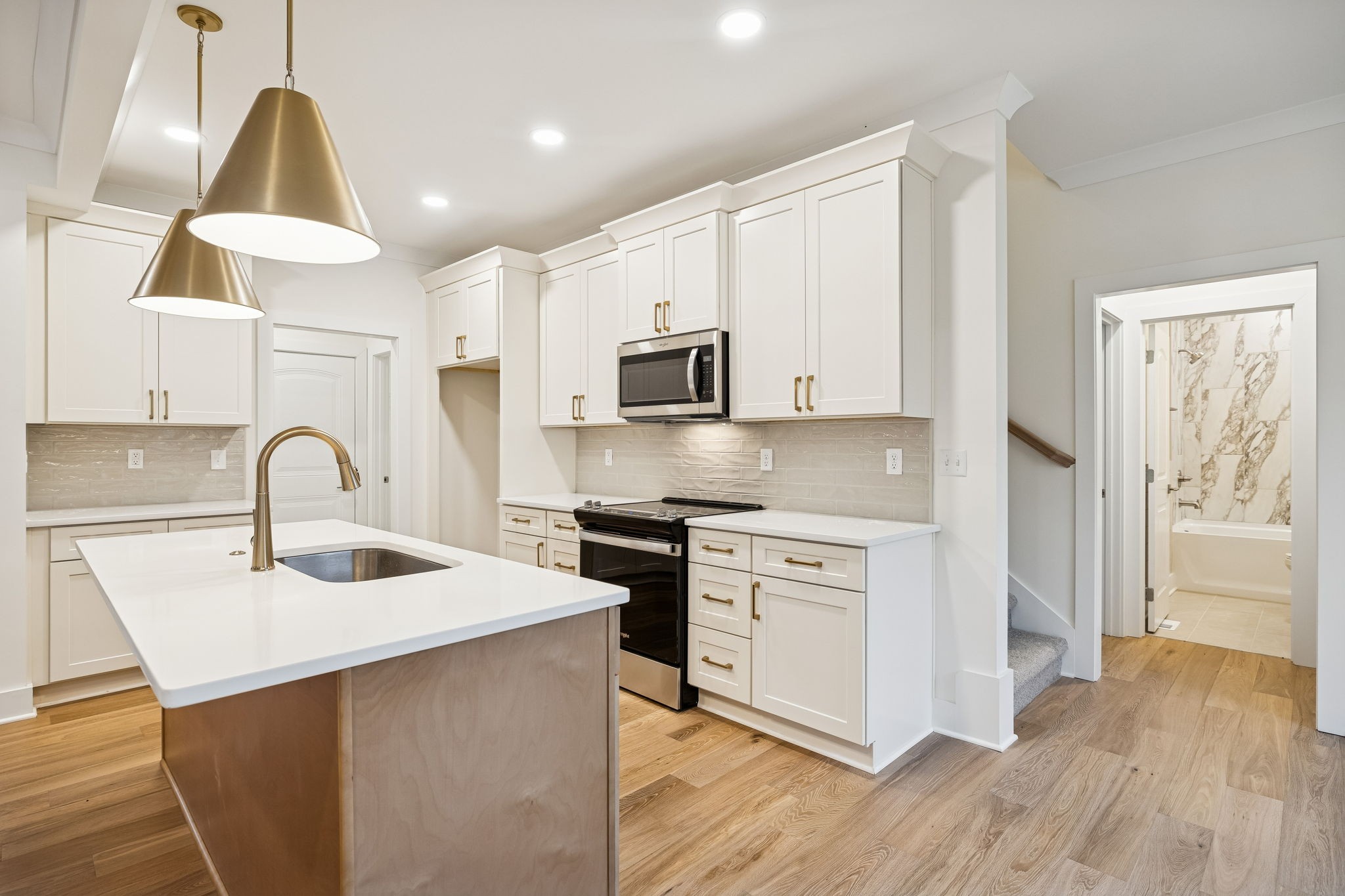 1561 Opossum Paw Road Beechgrove, TN 37018 - Photo 27 of 62 a kitchen with stainless steel appliances granite countertop a sink a stove and a refrigerator