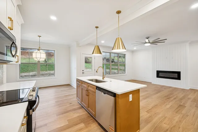 a white bath tub sitting next to a bathroom sink