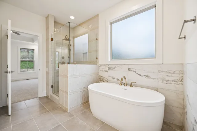 an empty room with a ceiling fan and a window