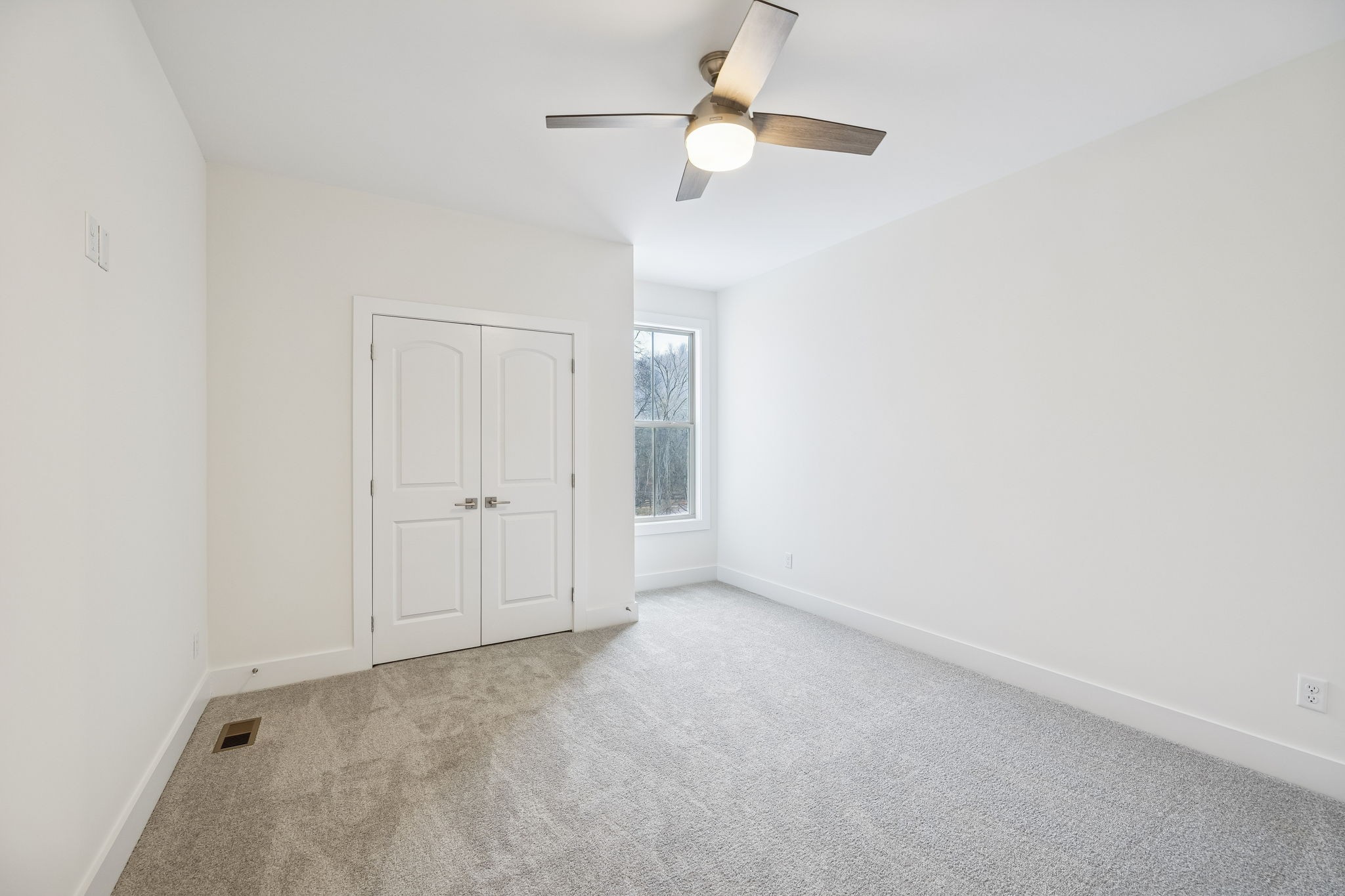 1561 Opossum Paw Road Beechgrove, TN 37018 - Photo 44 of 62 an empty room with a ceiling fan and a window