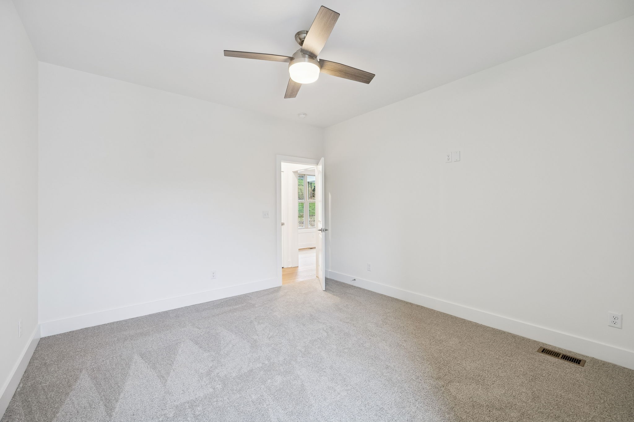 1561 Opossum Paw Road Beechgrove, TN 37018 - Photo 45 of 62 an empty room with a ceiling fan and a window