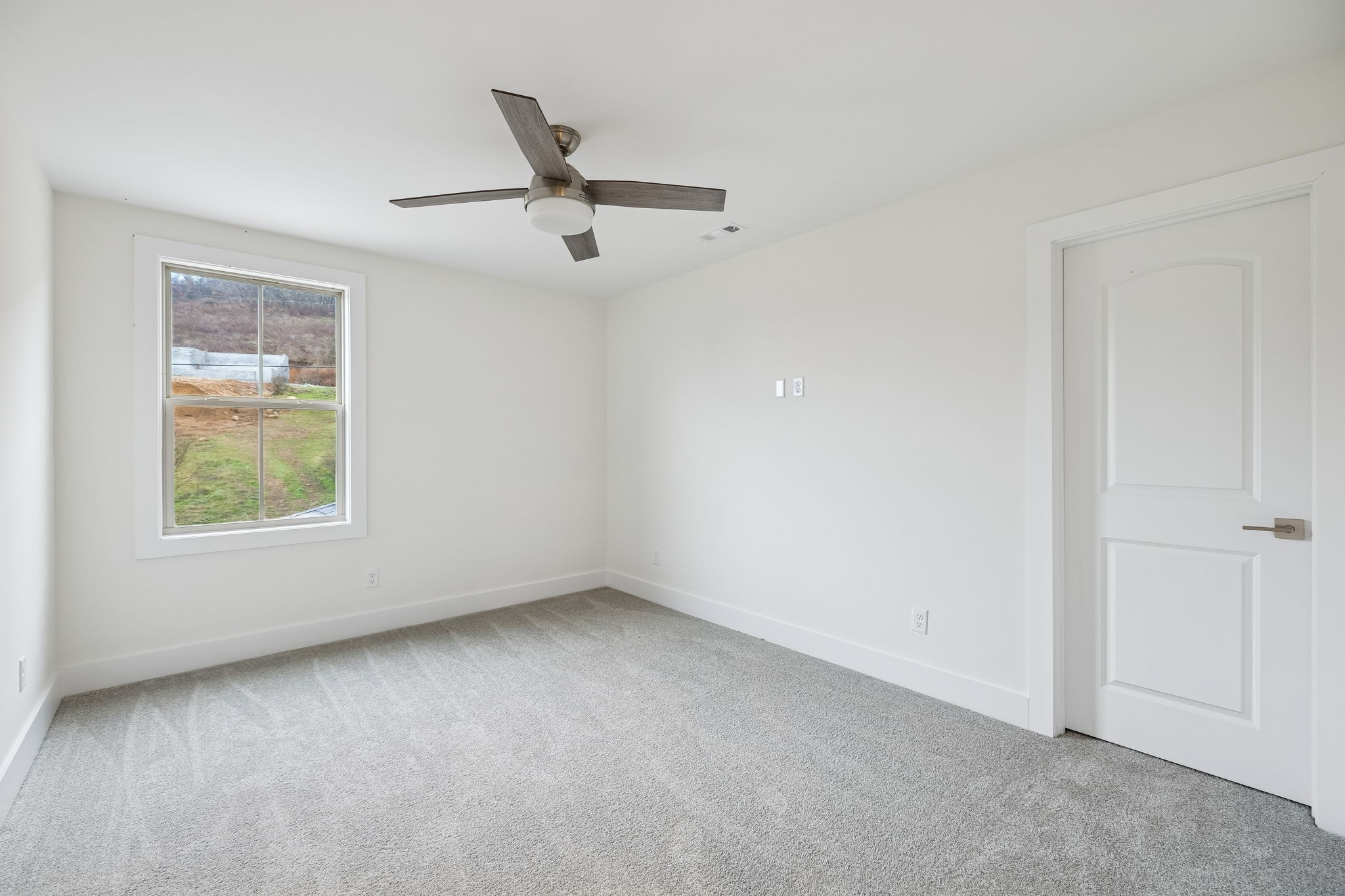 1561 Opossum Paw Road Beechgrove, TN 37018 - Photo 53 of 62 an empty room with a ceiling fan and a window