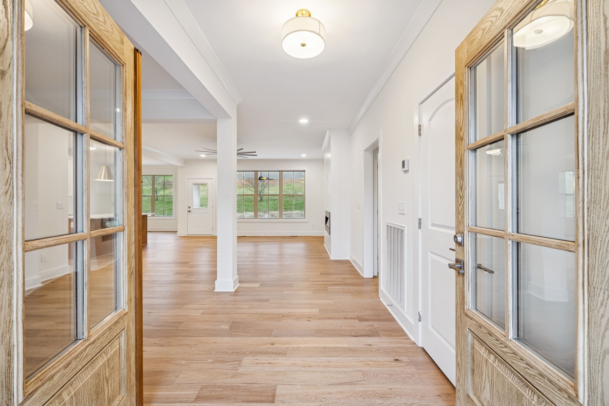 1561 Opossum Paw Road Beechgrove, TN 37018 - Photo 8 of 62 a view of a hallway with wooden floor and glass door