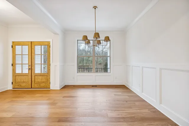 a view of empty room with wooden floor