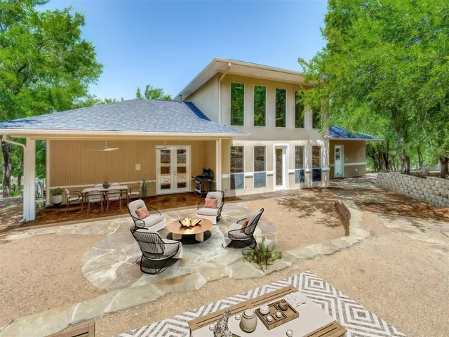 a patio with a table and chairs under an umbrella
