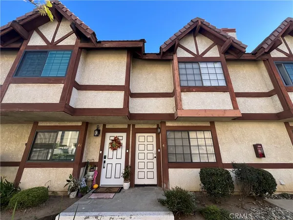 a front view of a house with large windows