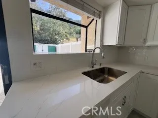 a kitchen with a sink and cabinets