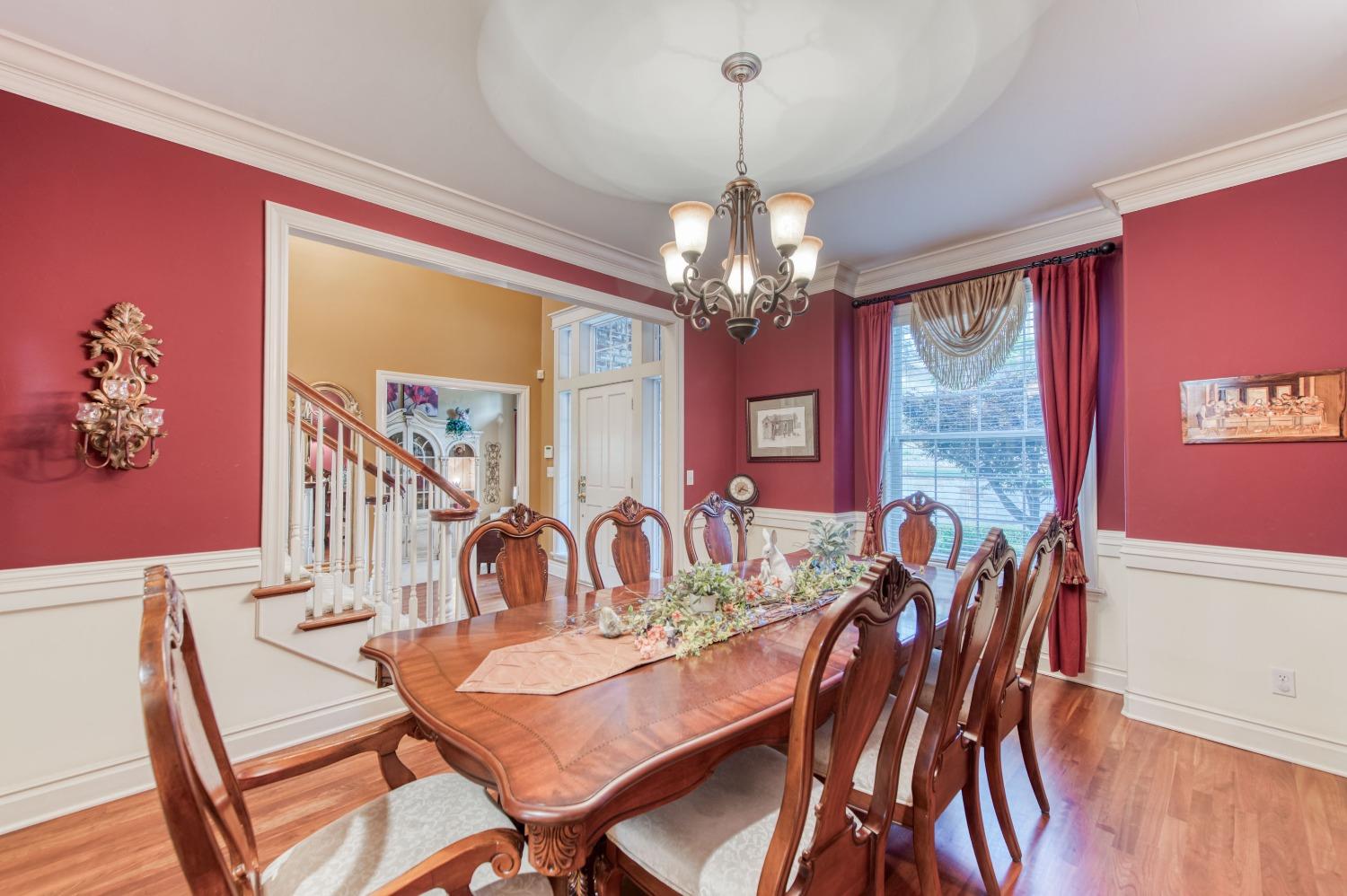 21672 Westmere Lane Friant, CA 93626 - Photo 18 of 80 a view of a dining room with furniture a chandelier and wooden floor