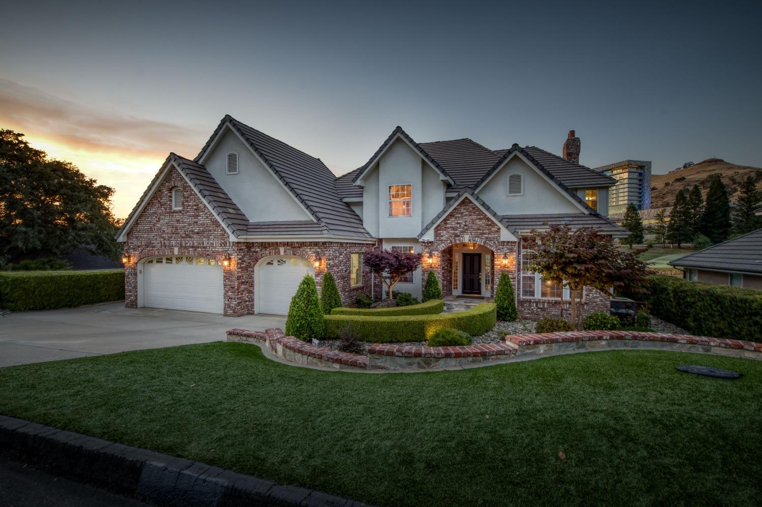 21672 Westmere Lane Friant, CA 93626 - Photo 2 of 80 a front view of a house with a yard and green space