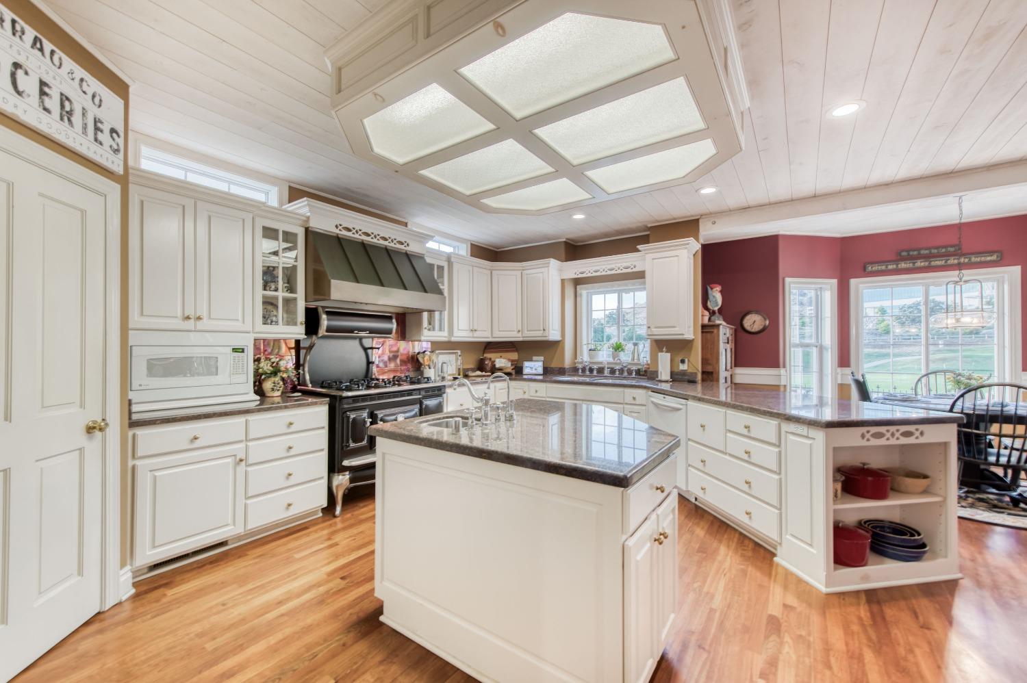 21672 Westmere Lane Friant, CA 93626 - Photo 24 of 80 a kitchen with stainless steel appliances granite countertop a stove and a sink