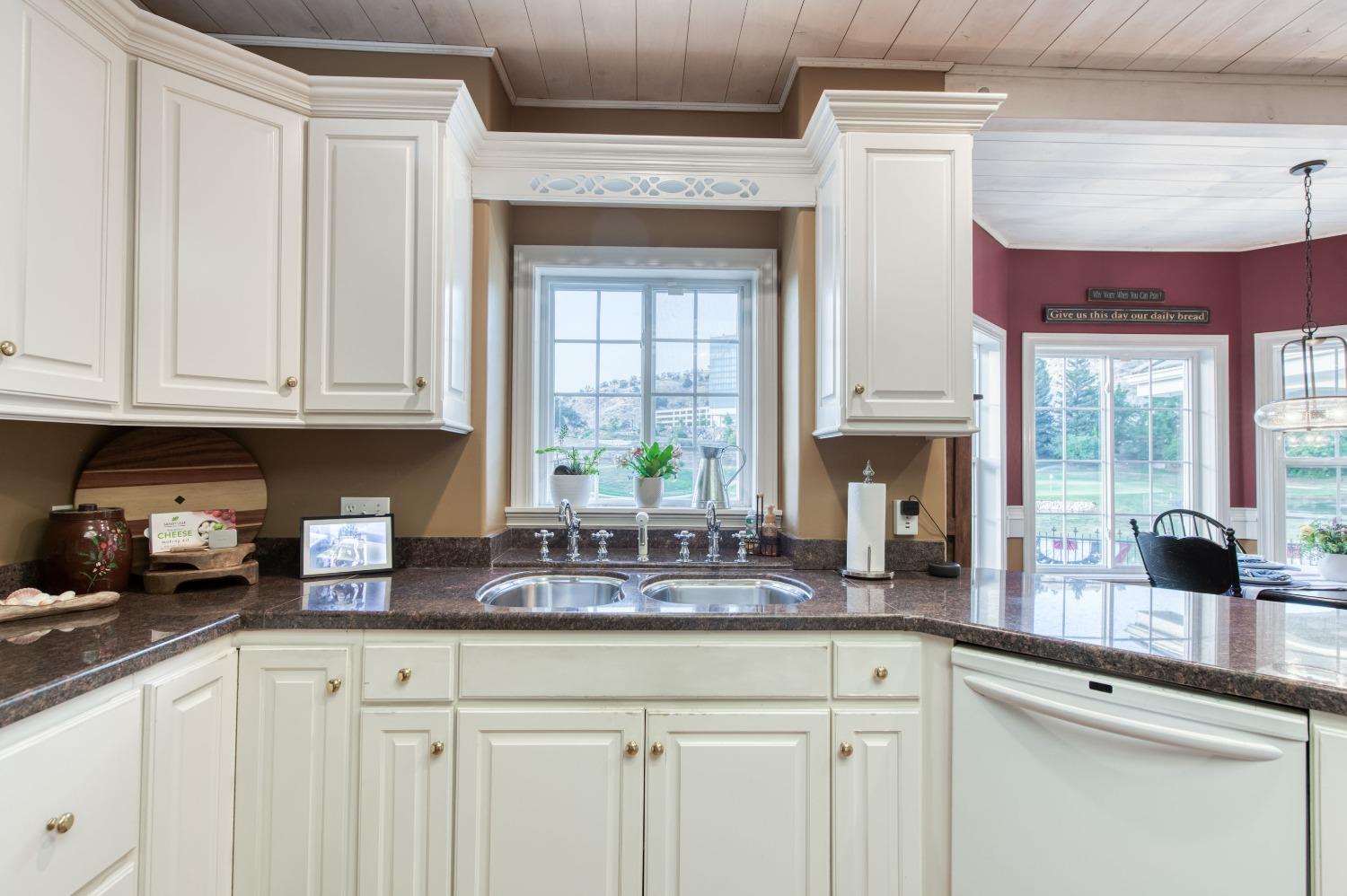 21672 Westmere Lane Friant, CA 93626 - Photo 29 of 80 a kitchen with stainless steel appliances granite countertop a sink a stove and a granite counter tops with white cabinets