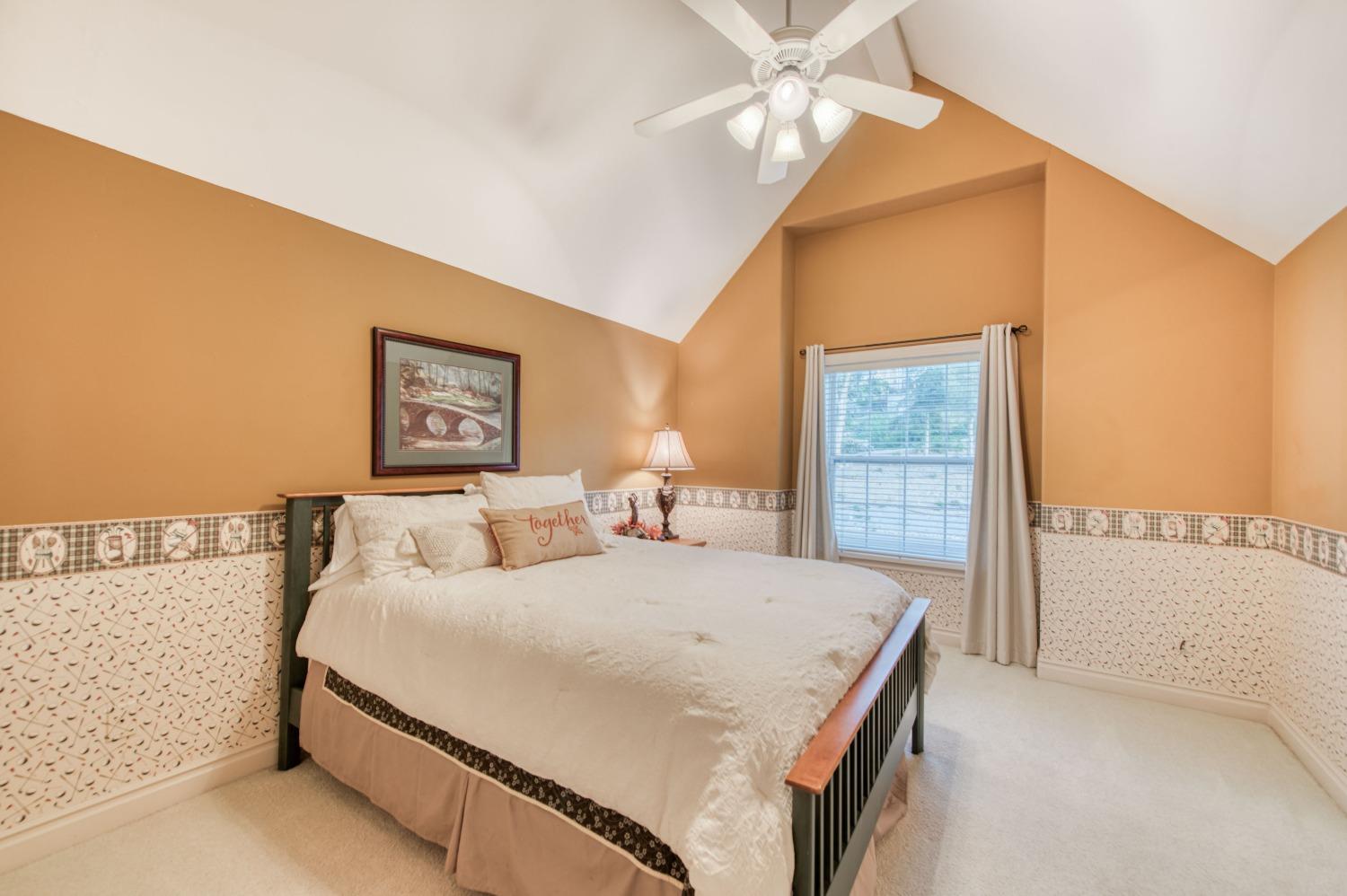 21672 Westmere Lane Friant, CA 93626 - Photo 35 of 80 a bedroom with a bed and a chandelier