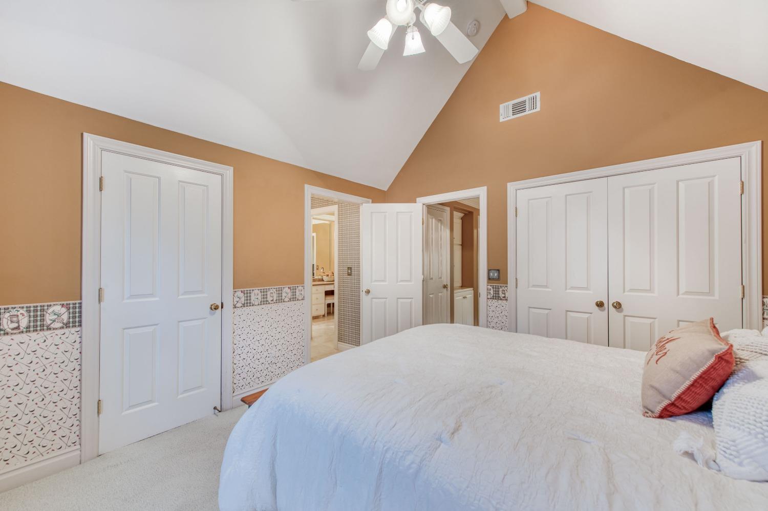 21672 Westmere Lane Friant, CA 93626 - Photo 36 of 80 a spacious bedroom with a bed and a lamp