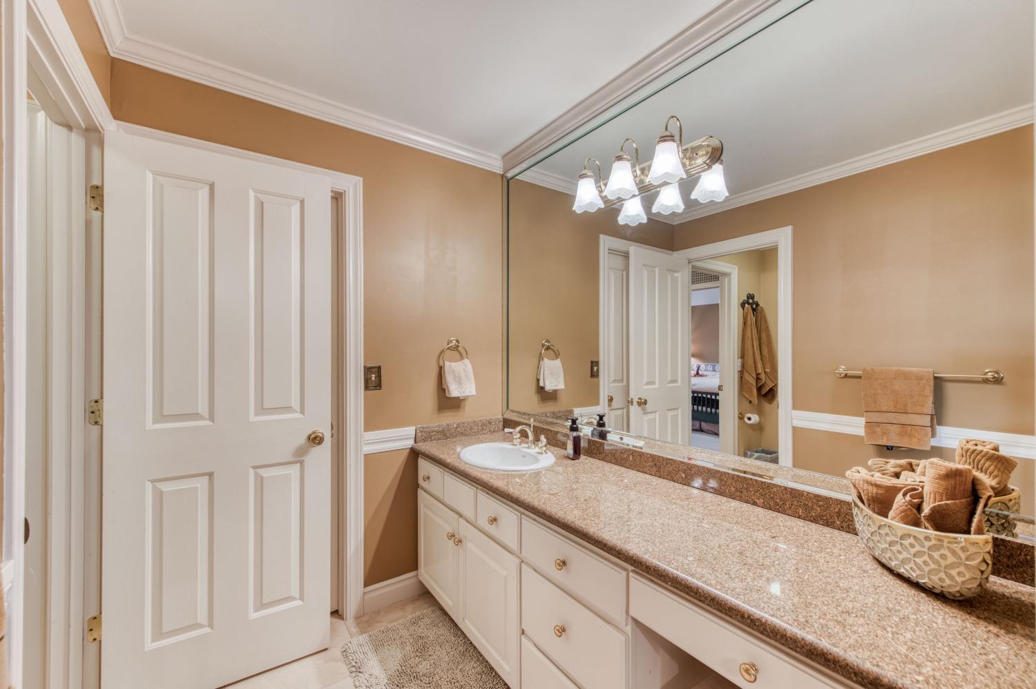 21672 Westmere Lane Friant, CA 93626 - Photo 39 of 80 a bathroom with double vanity and a mirror