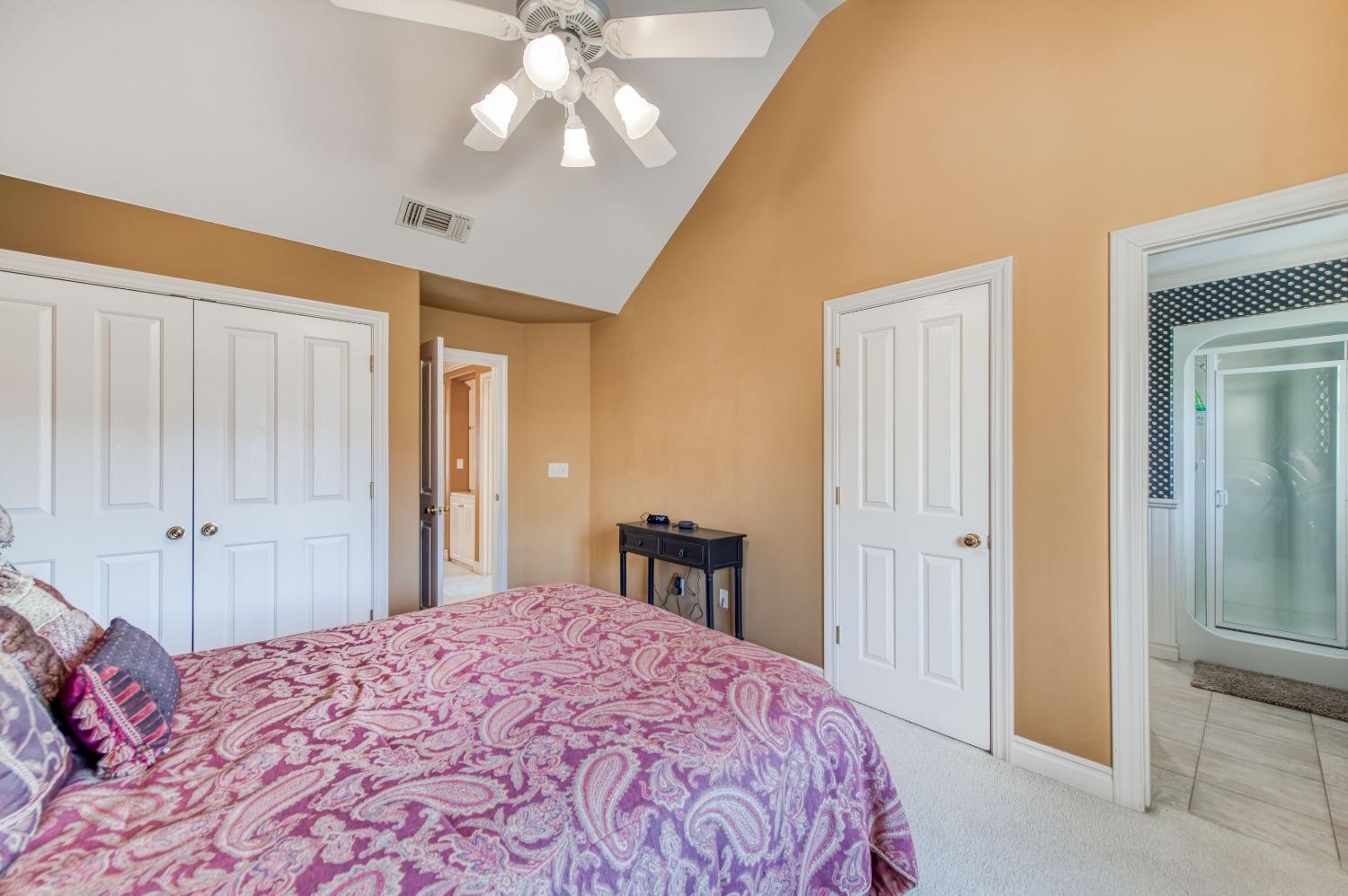 21672 Westmere Lane Friant, CA 93626 - Photo 42 of 80 a bedroom with a bed and a chandelier