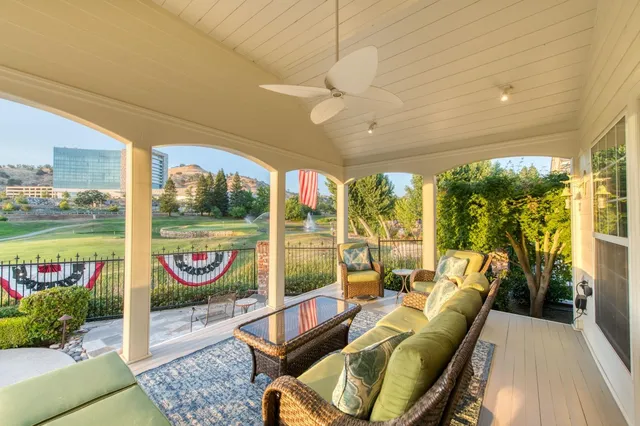 an aerial view of residential houses with outdoor space and trees
