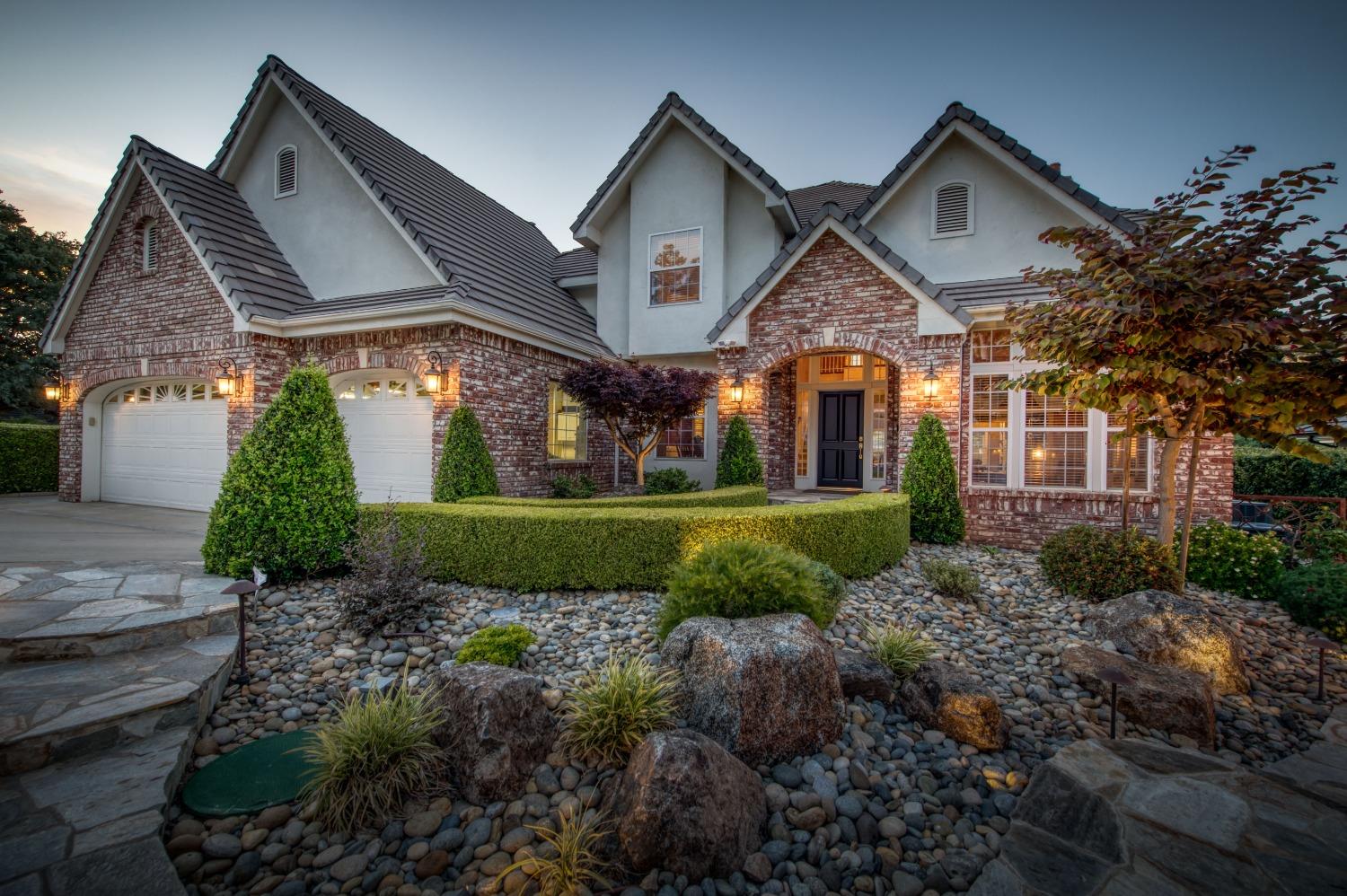 21672 Westmere Lane Friant, CA 93626 - Photo 65 of 80 a front view of a house with a yard and garage