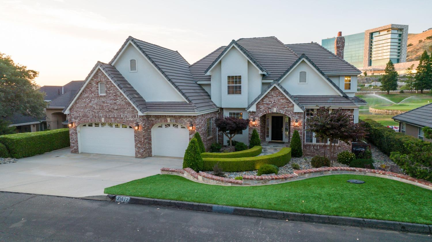 21672 Westmere Lane Friant, CA 93626 - Photo 70 of 80 a front view of a house with a yard and garage
