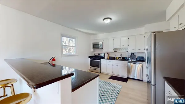 a kitchen with a sink appliances and cabinets