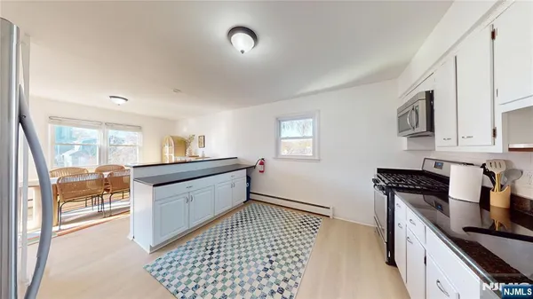 a kitchen with granite countertop a sink stove and cabinets